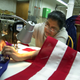 Sadgunaben Patel adjusts her sewing machine as she sews an American Flag at Annin Flags, April 7, 2003, in Oaks, Pennsylvania